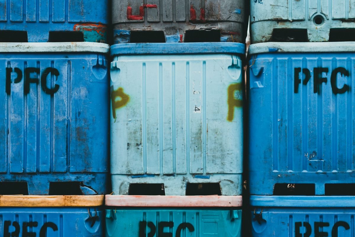 Blue HDPE plastic bottles used for industrial solvent and chemical packaging